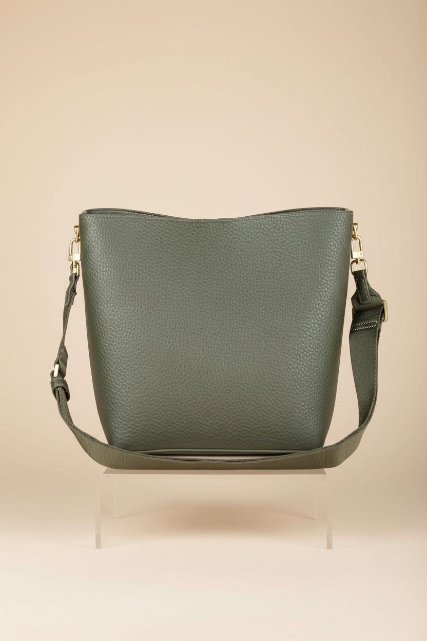 Amazon Essentials dark olive handbag on a warm beige backdrop, highlighting its design features.