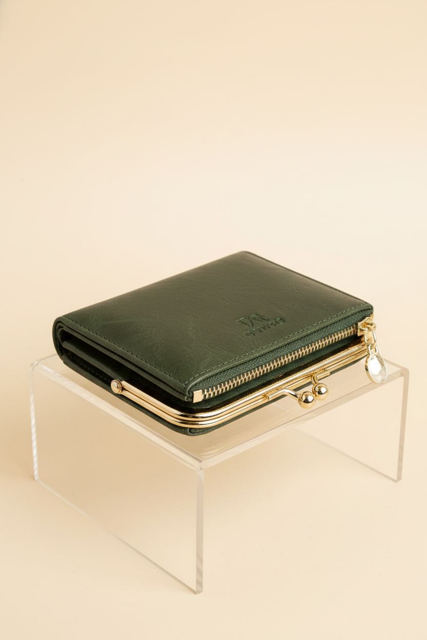 AOXONEL compact green wallet on a studio set, emphasizing its elegant zipper and kiss-lock features.