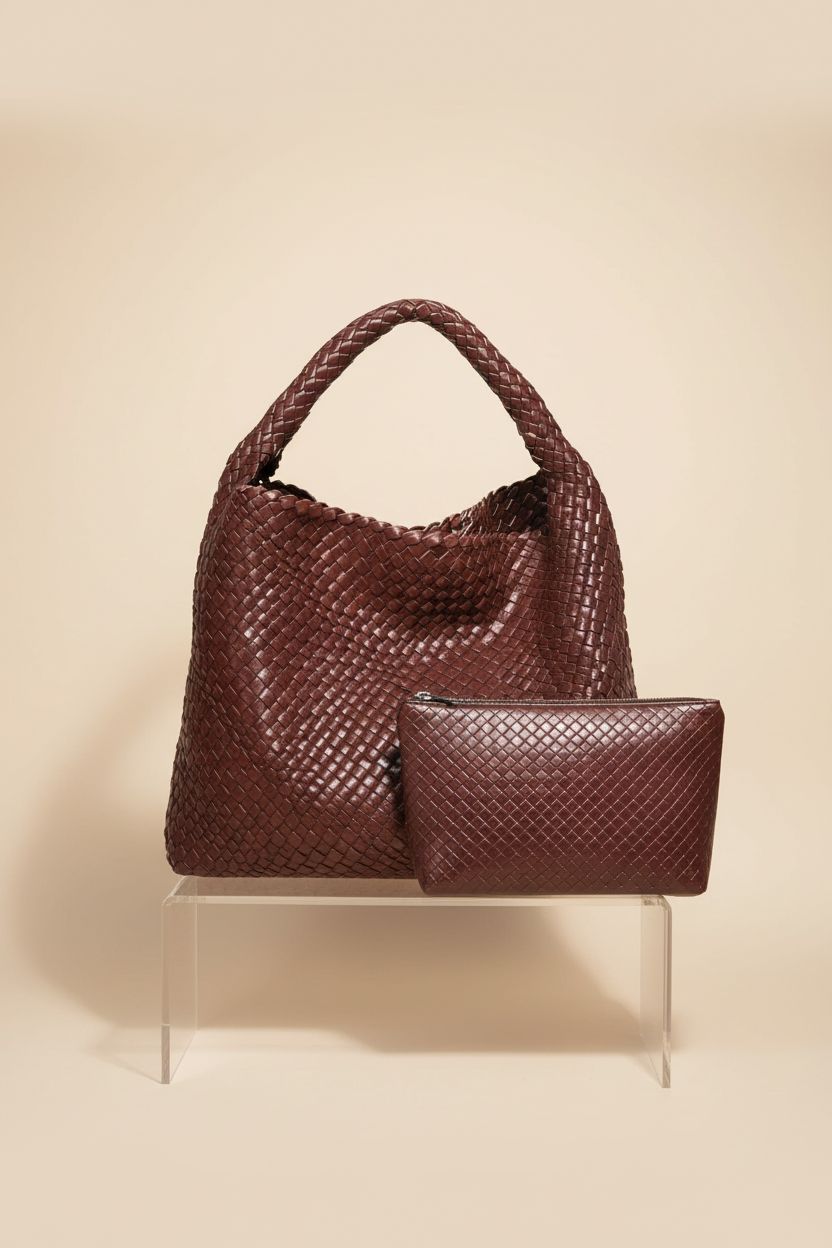 Geelyda woven leather tote and matching clutch displayed elegantly on a seamless background.