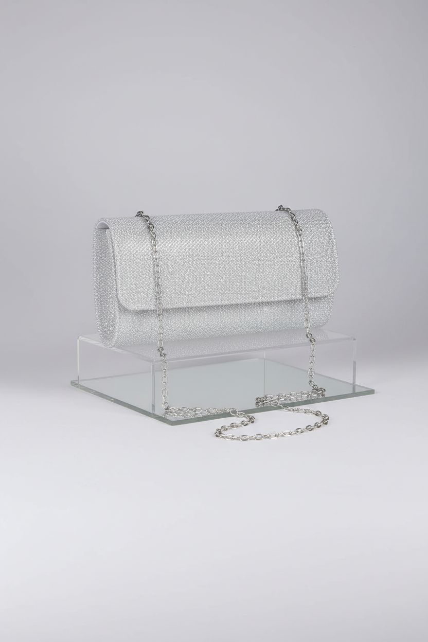 lovyoCoCo clutch bag displayed on a gray background, emphasizing its glitter fabric and elegant design.