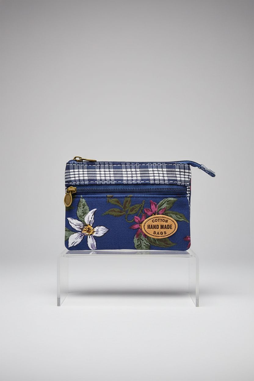 GUXL handmade fabric purse with floral embroidery displayed on a light gray backdrop, highlighting its design