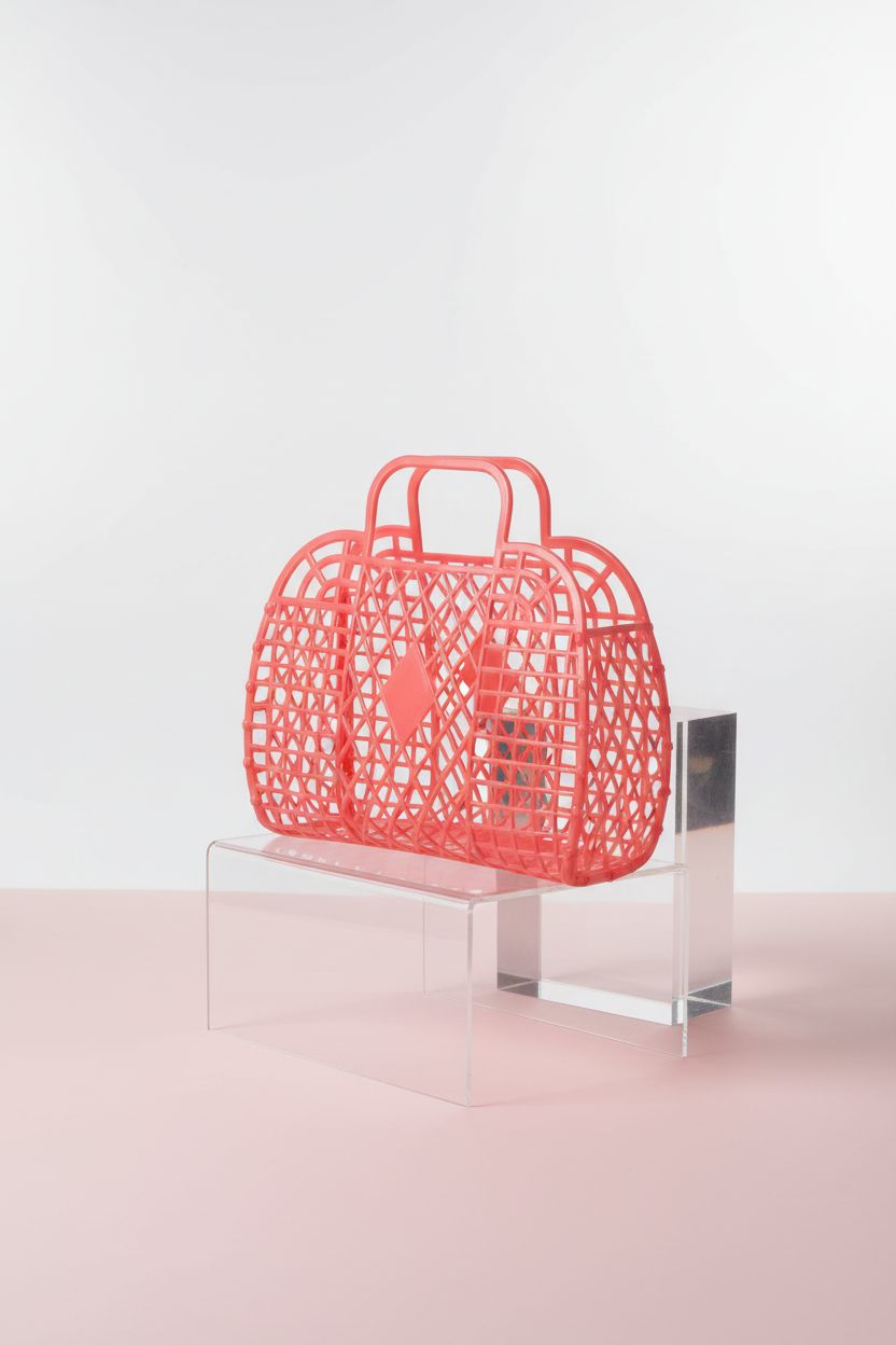 Product-focused shot of Generic red jelly purse on a clear pedestal, highlighting its diamond lattice and sleek design.