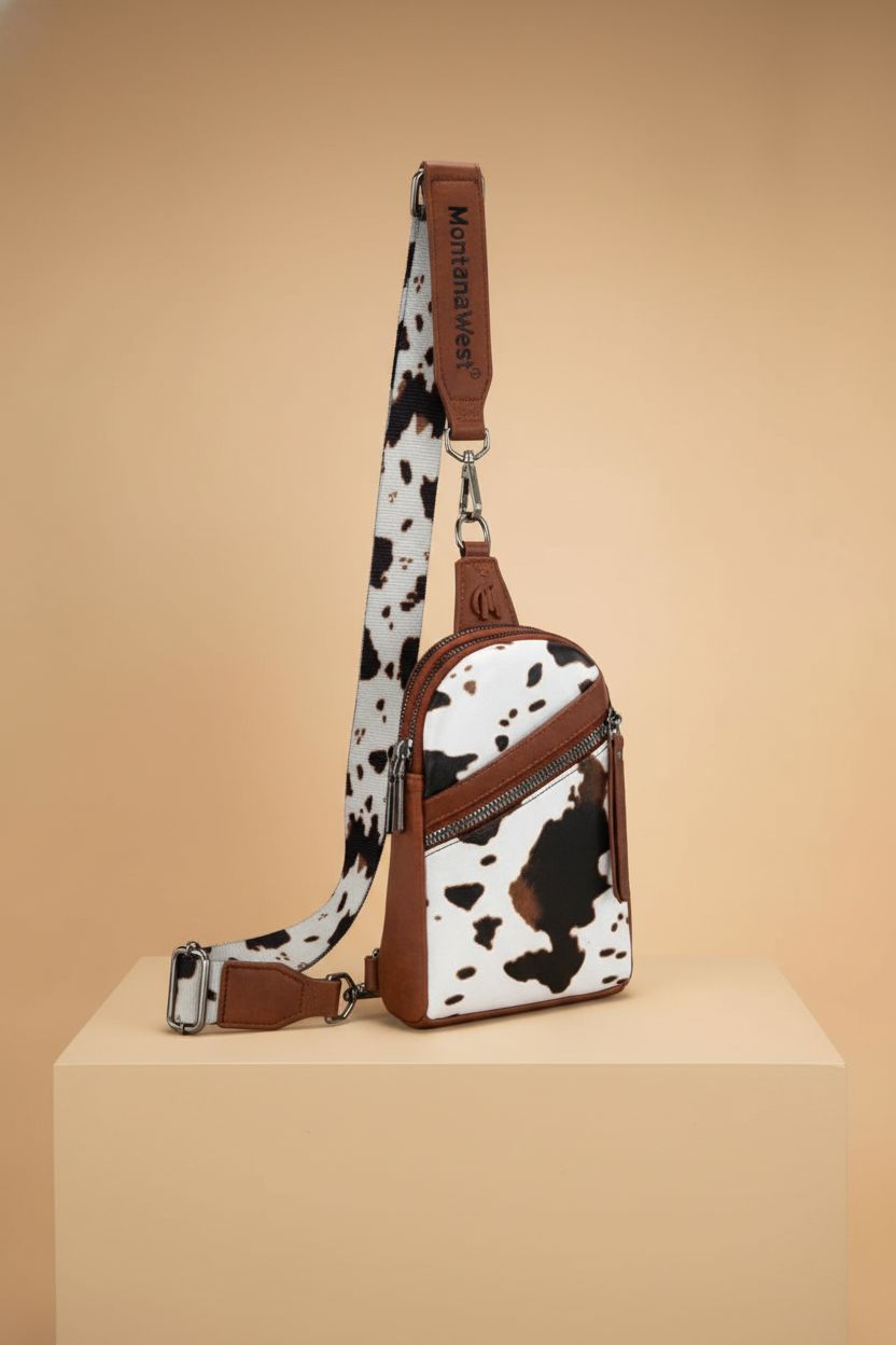Montana West western cow print crossbody purse displayed on a seamless backdrop to highlight its features