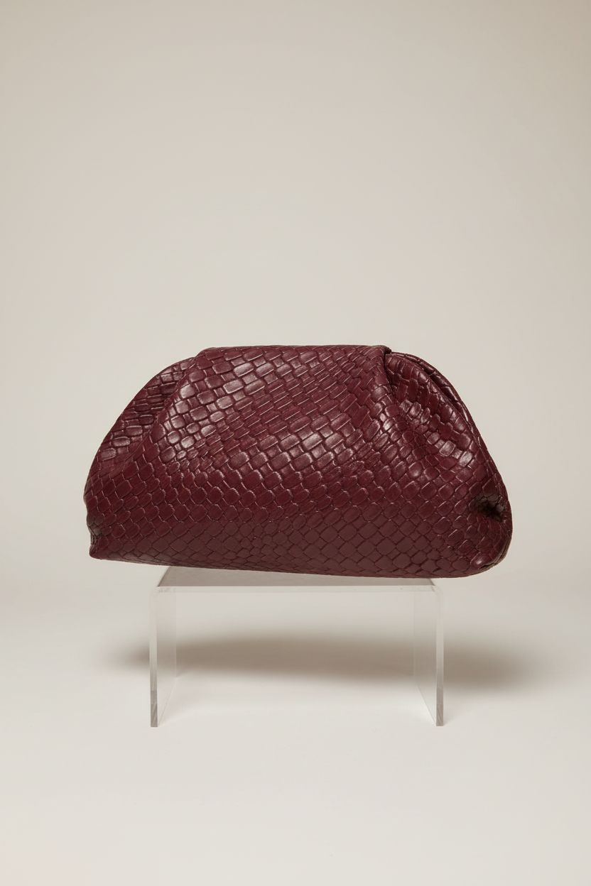 QWINEE burgundy woven clutch on seamless backdrop, emphasizing its stylish ruched top and refined details.