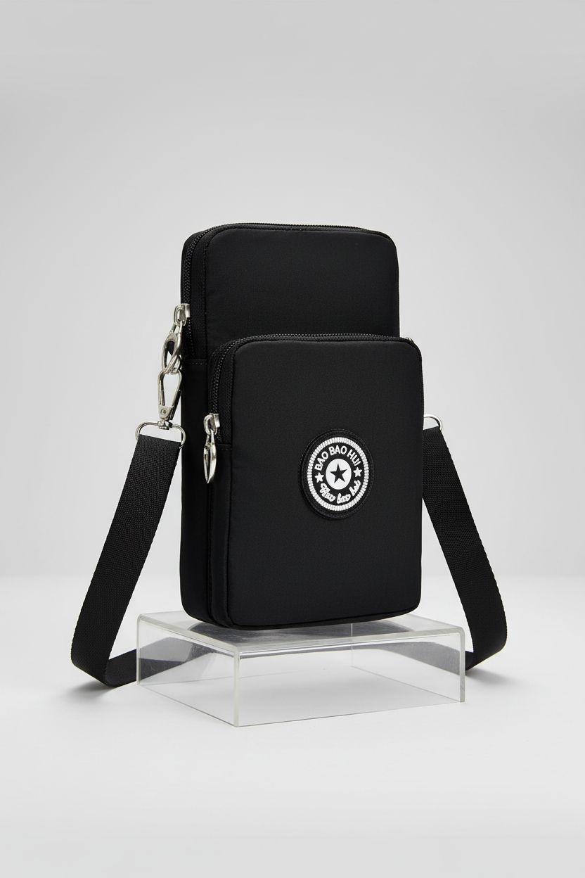 Detailed view of JANKS black nylon bag on display, showcasing stitching and adjustable strap.