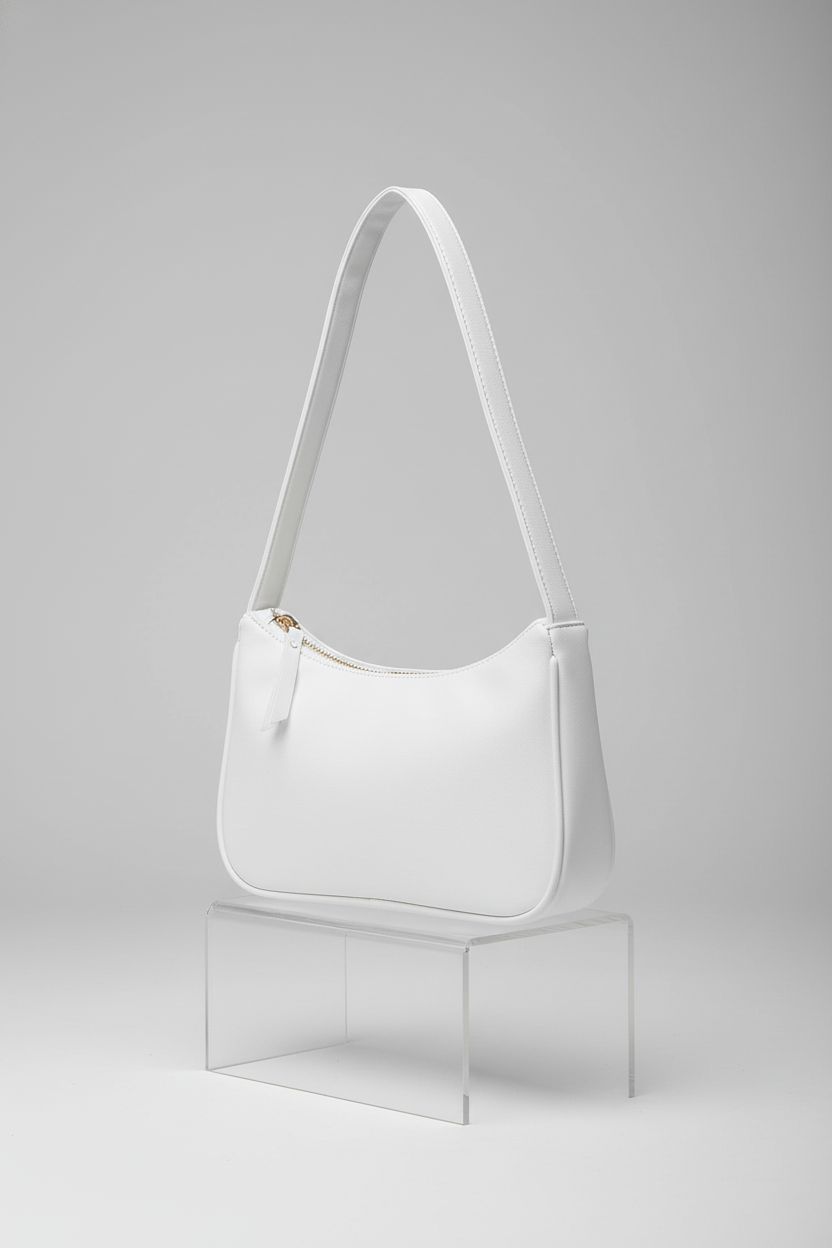 Brymthy white mini hobo bag showcased on a sleek block against a gray backdrop, highlighting its stylish design.