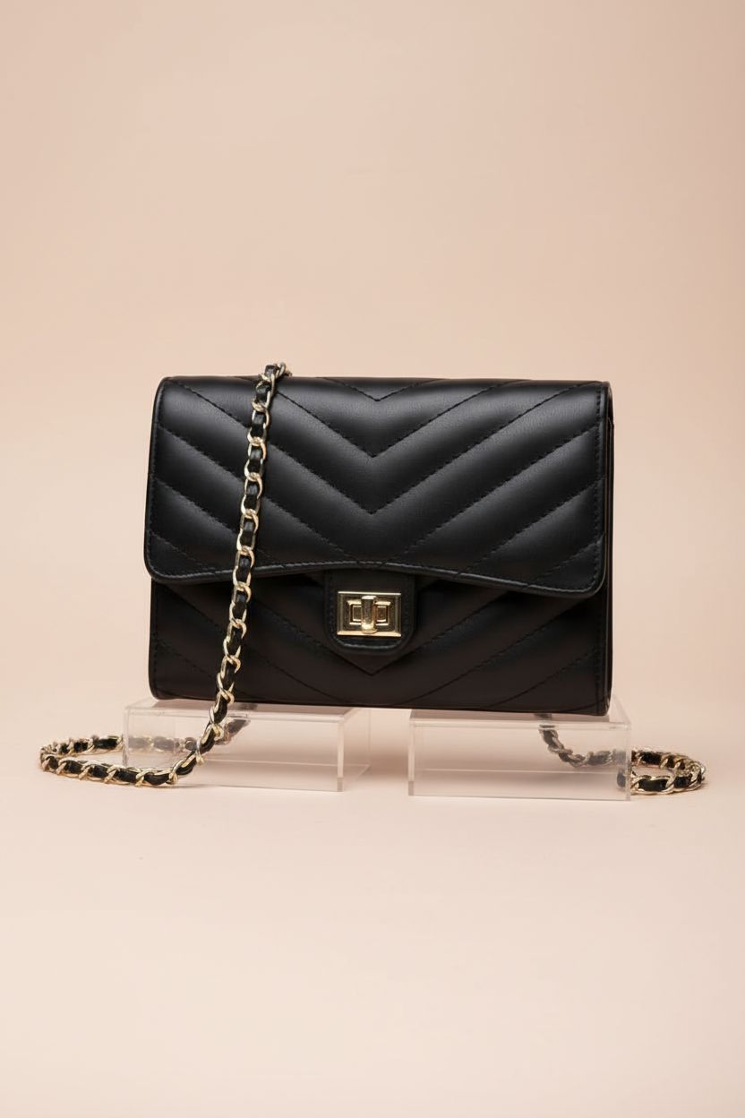 Detailed view of YAZEKOUS small crossbody purse on acrylic risers, highlighting elegant design and quality.