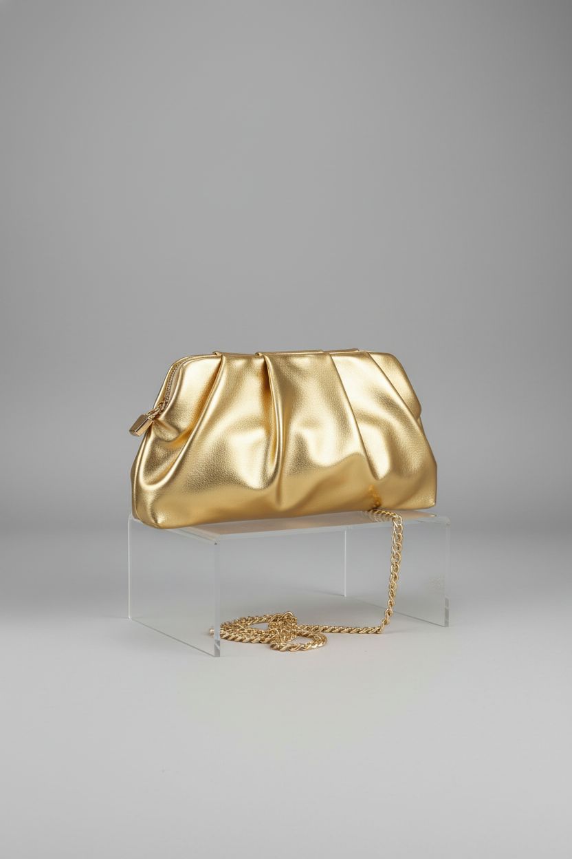 FanChris gold clutch showcased against a gray background, highlighting its design.