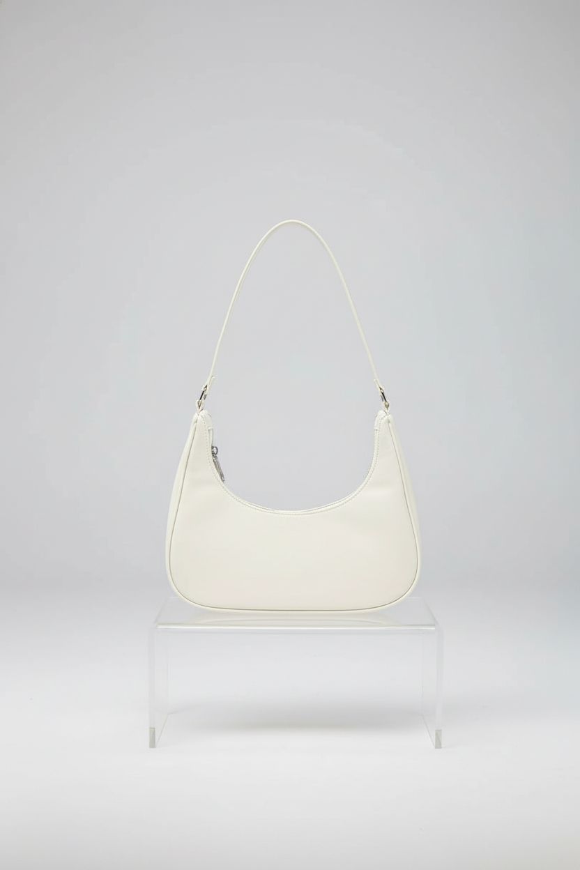 WisePoint Women's Crescent Bag displayed on a clear riser, highlighting its modern design and quality craftsmanship.