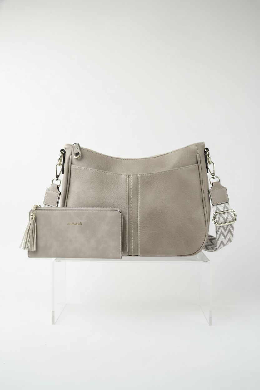 TANTOMI grey vegan leather crossbody purse and wallet on a studio backdrop