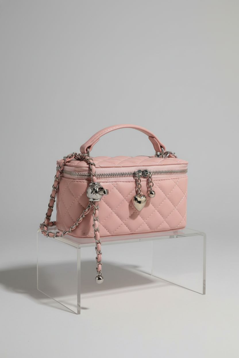 Product shot of MZE JPLAN blush-pink box square handbag with polished hardware and chain.