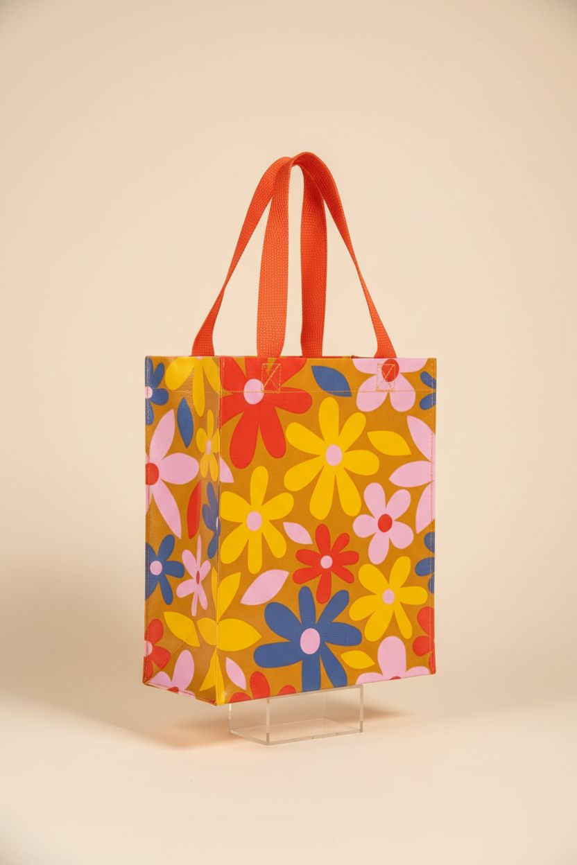 Blue Q Handy Tote Bag displayed in a studio, highlighting its sturdy design and 95% recycled material.