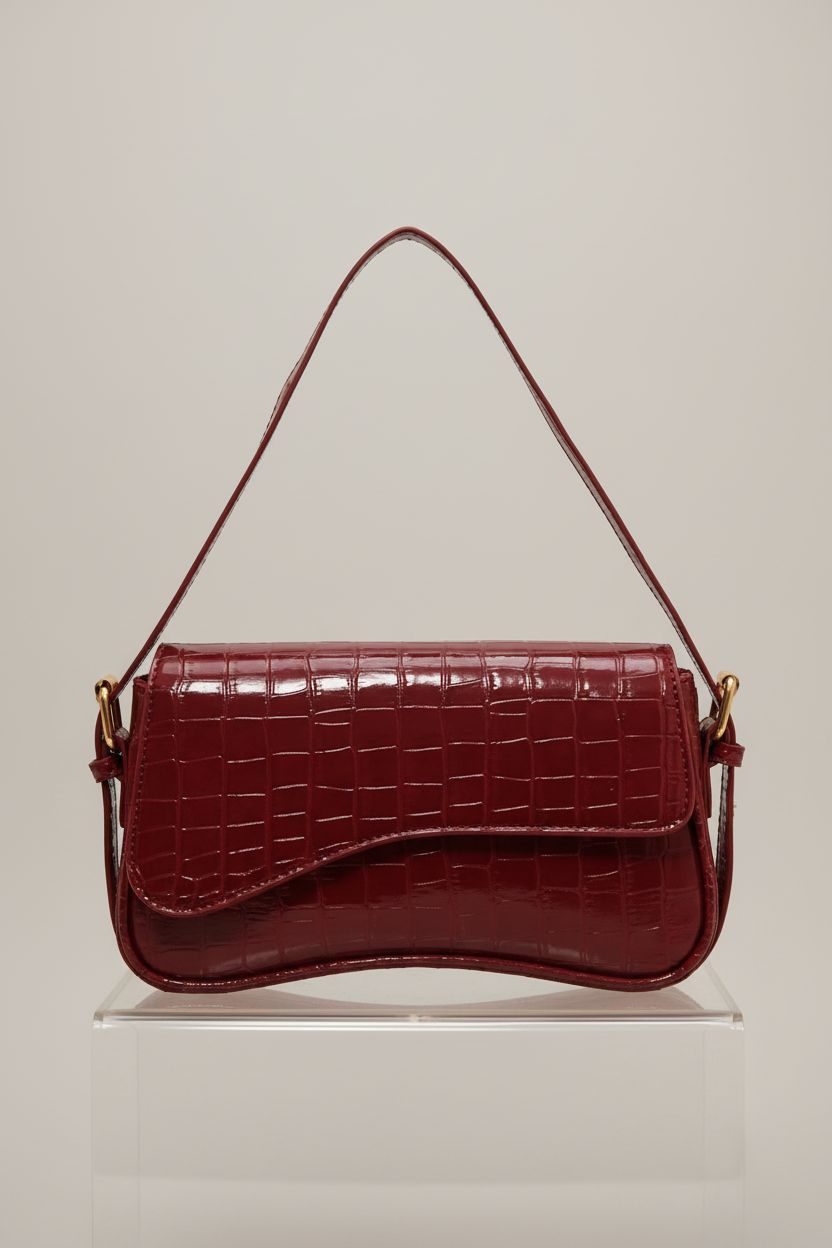 HitTopss burgundy croc-embossed handbag displayed in a clean studio with focus on craftsmanship.