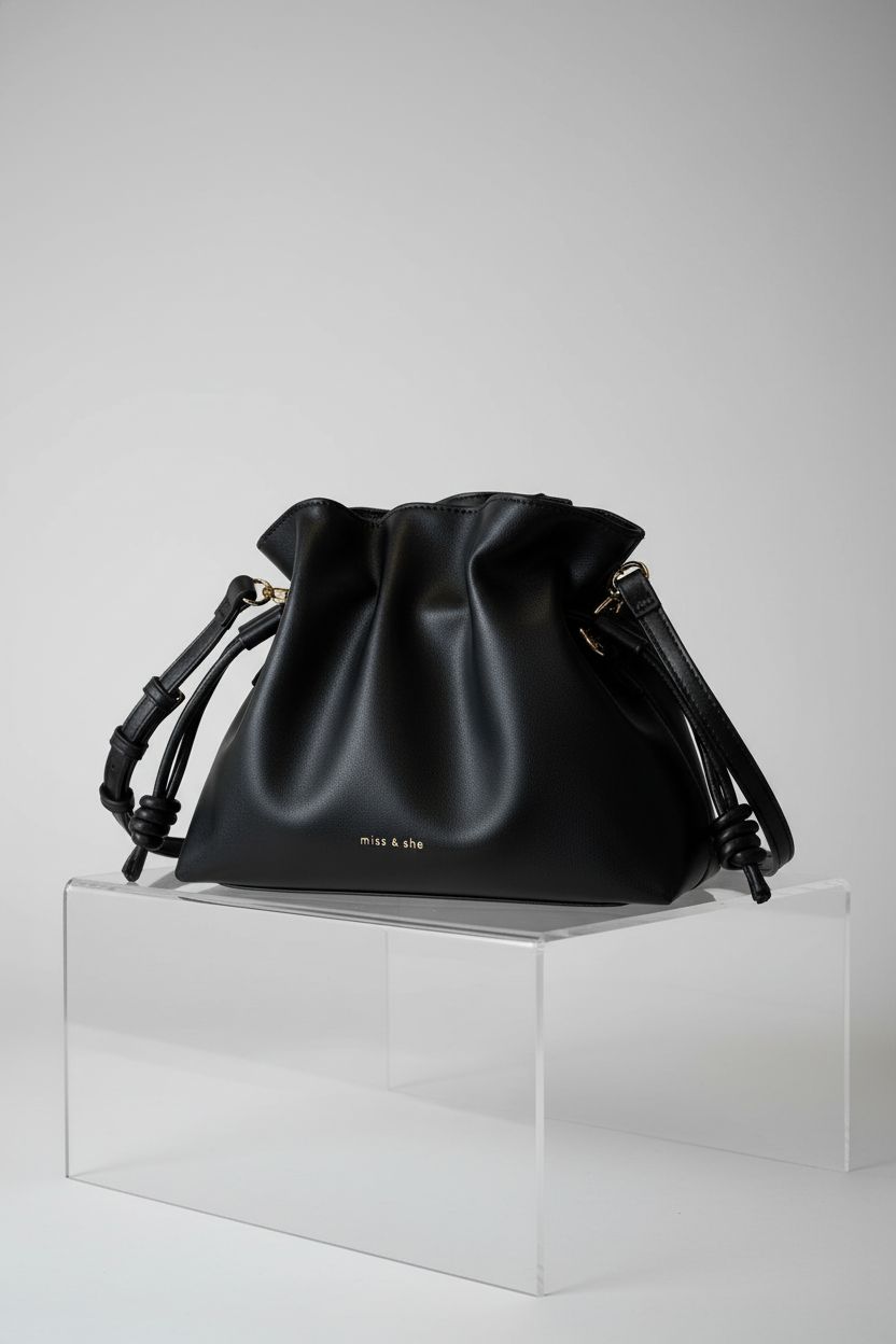 UICIOP black drawstring bucket bag featured on light gray backdrop, showcasing design