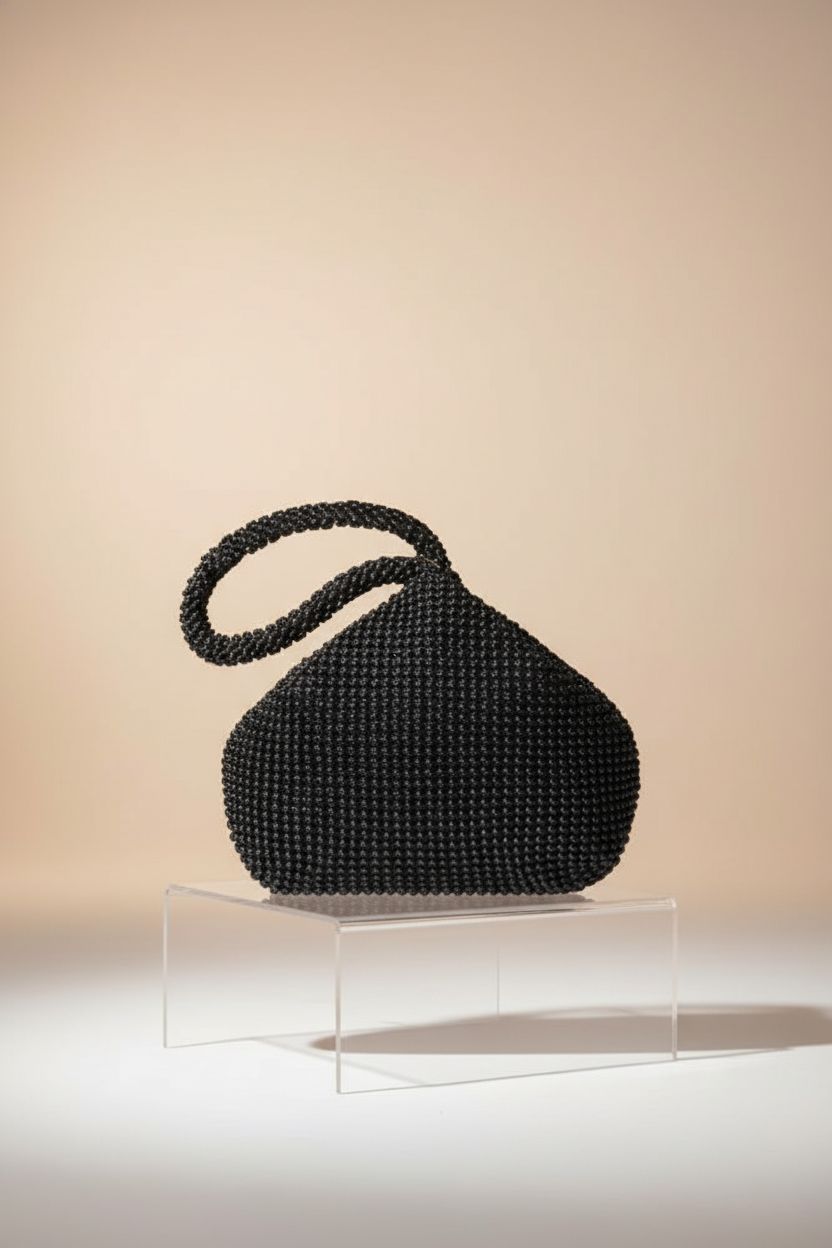 Product shot of BABEYOND triangular evening bag showcasing bead details and craftsmanship