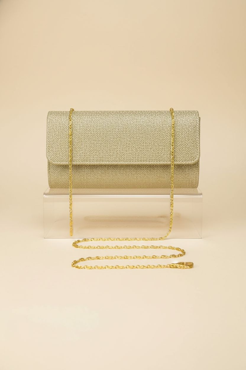 Product shot of lovyoCoCo gold purse highlighting its structured silhouette and chain.