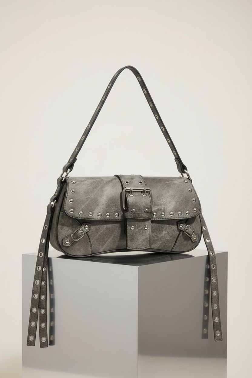 Close-up of Verdusa's grey handbag on a warm-gray set, showcasing its craftsmanship and details.