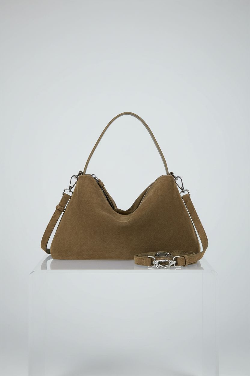 DONNAIN camel suede crossbody bag showcased on a light-gray pedestal