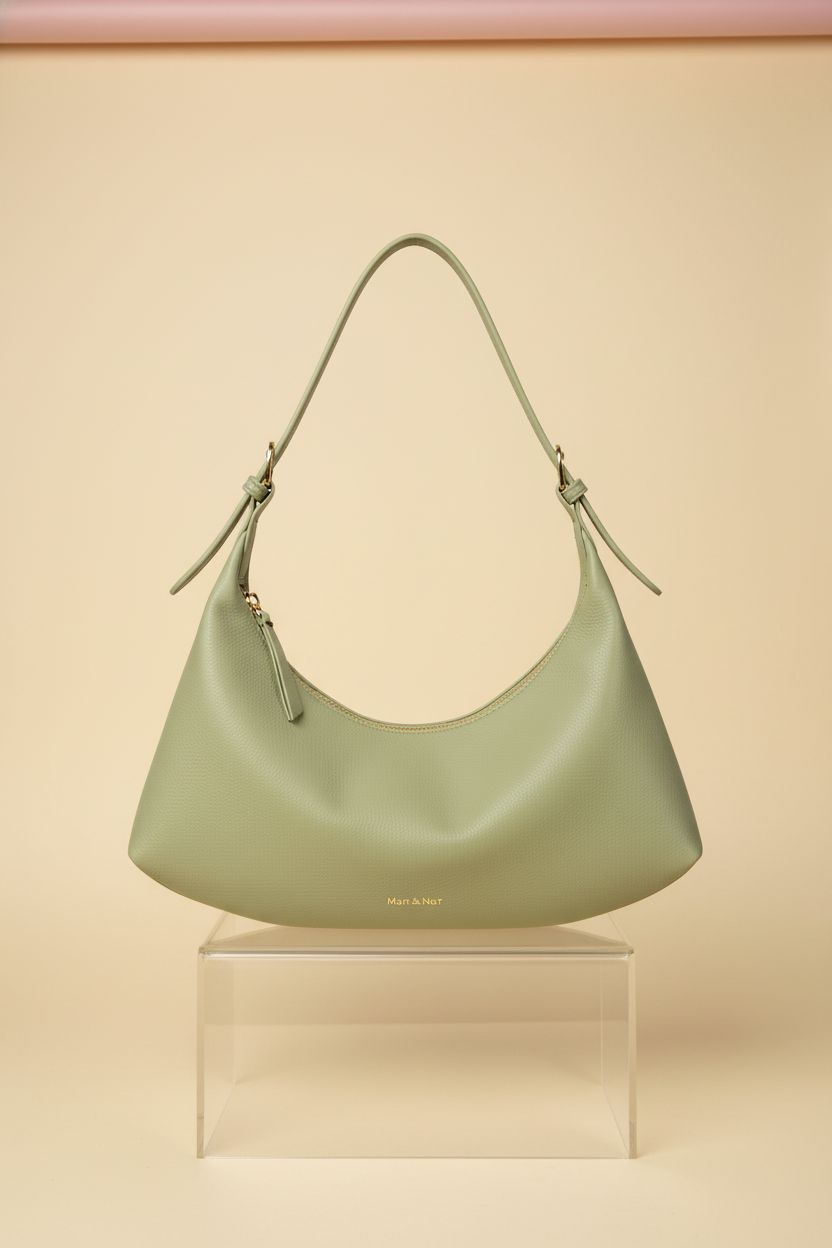 Close-up of Montana West sage crescent bag showcasing fine stitching and vegan leather.