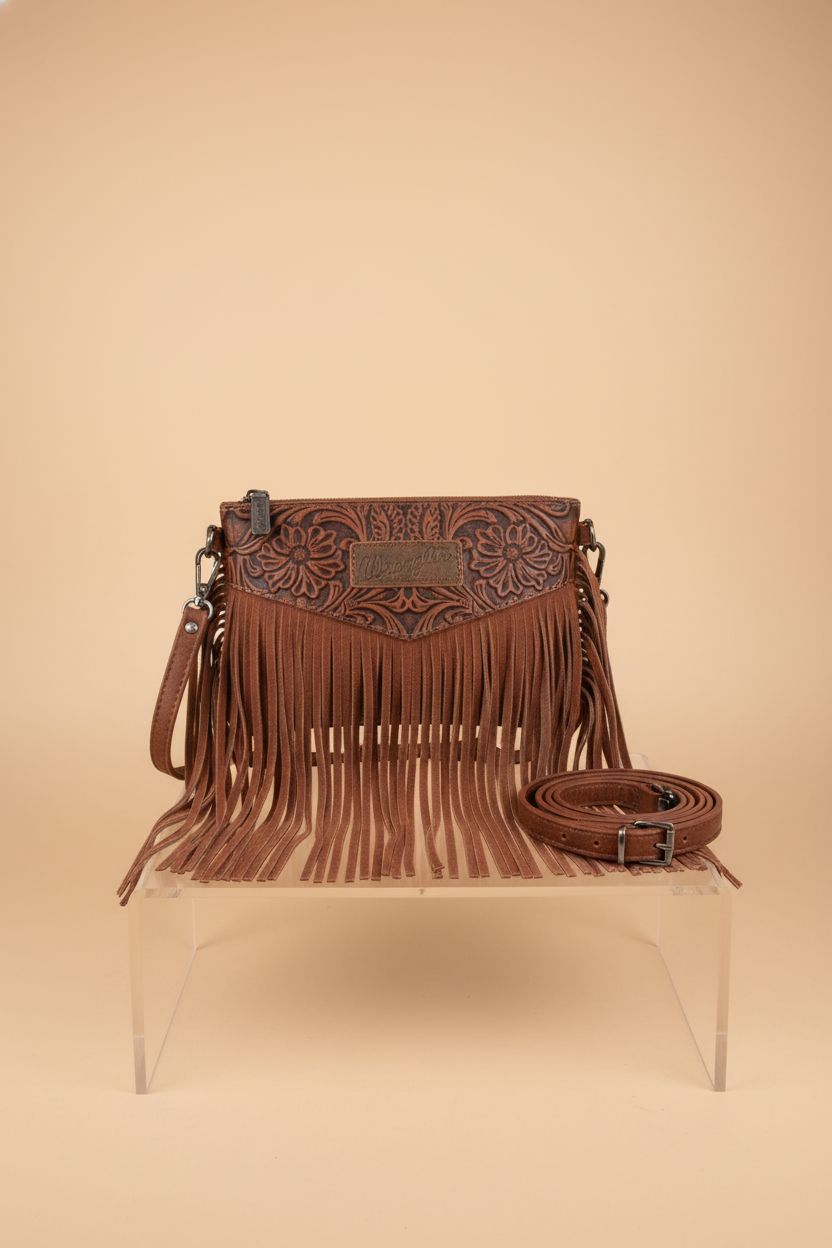 Montana West Wrangler Clutch Wristlet Fringe Purse showcased on a studio backdrop