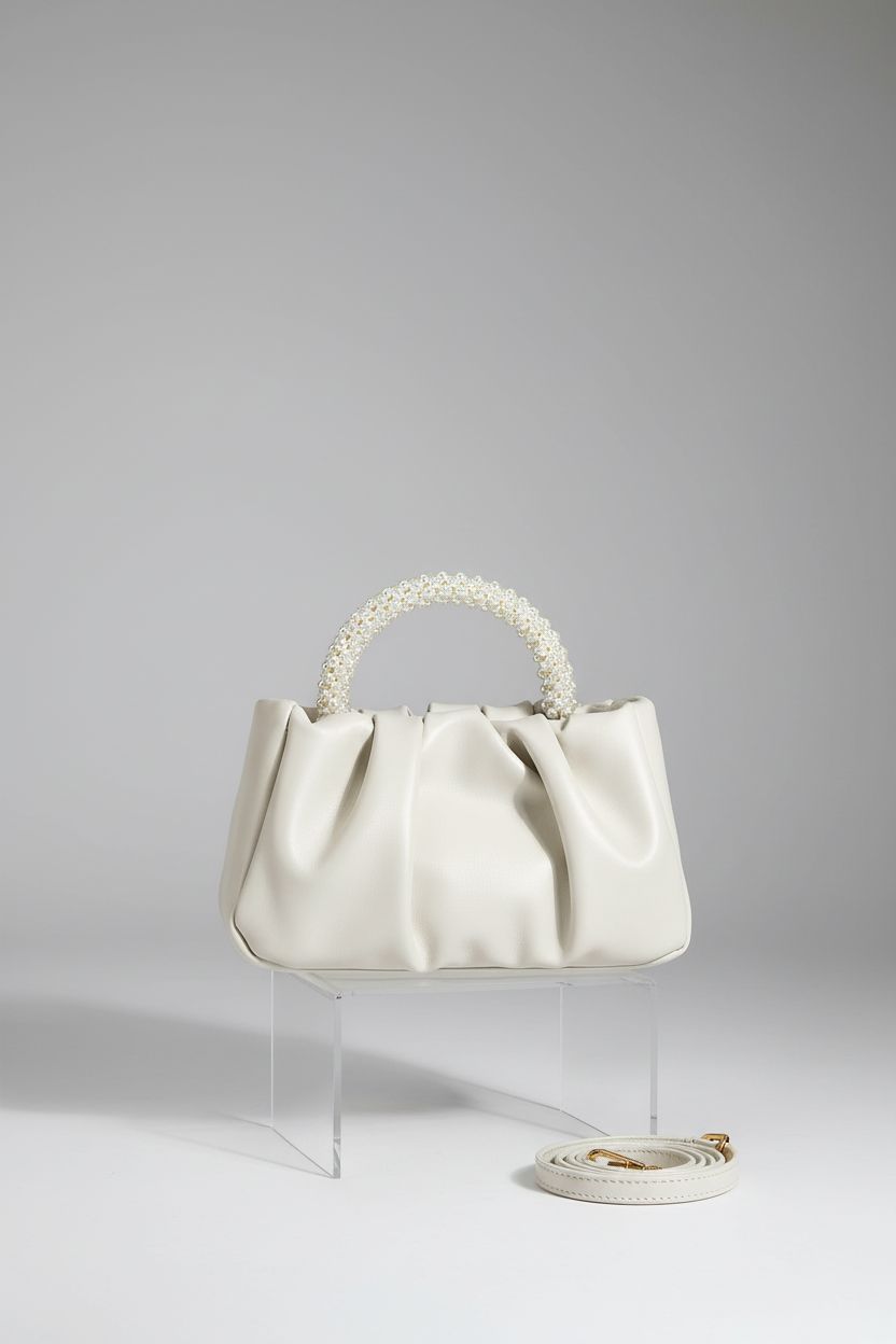 Beatfull stylish ruched leather purse on a grey backdrop, highlighting its design