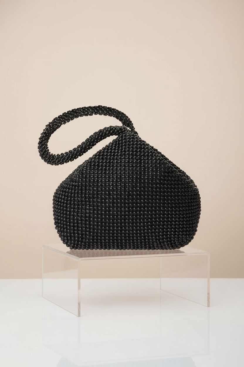 BABEYOND beaded triangle clutch displayed on an acrylic riser with a chic design.