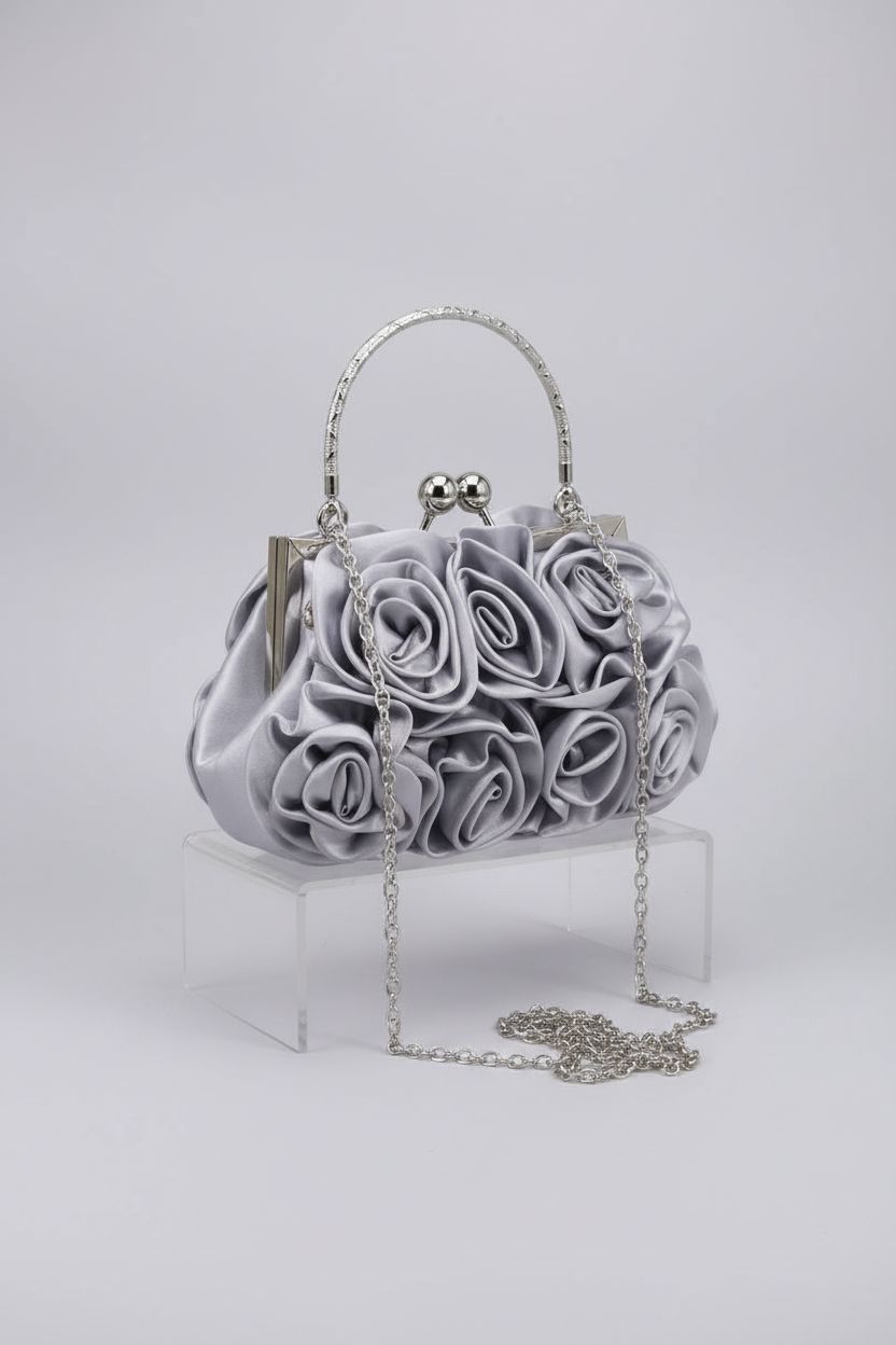 Product shot of JAMBHALA silver floral evening clutch bag showcasing intricate design details