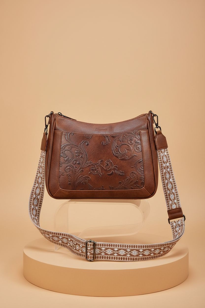 VIMUTI embossed crossbody bag displayed on a pedestal, showcasing its exquisite details.