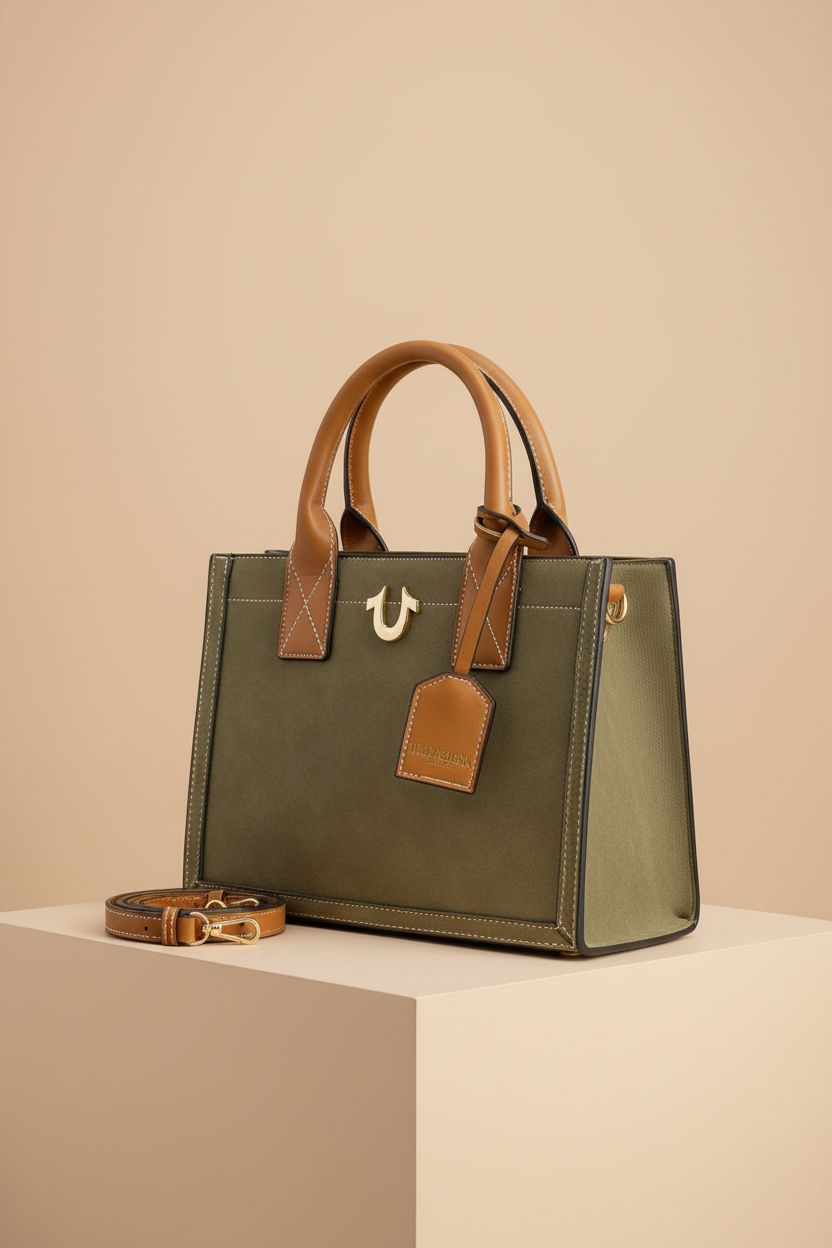 True Religion olive green faux suede tote bag on a neutral backdrop, showcasing its elegant design and gold hardware