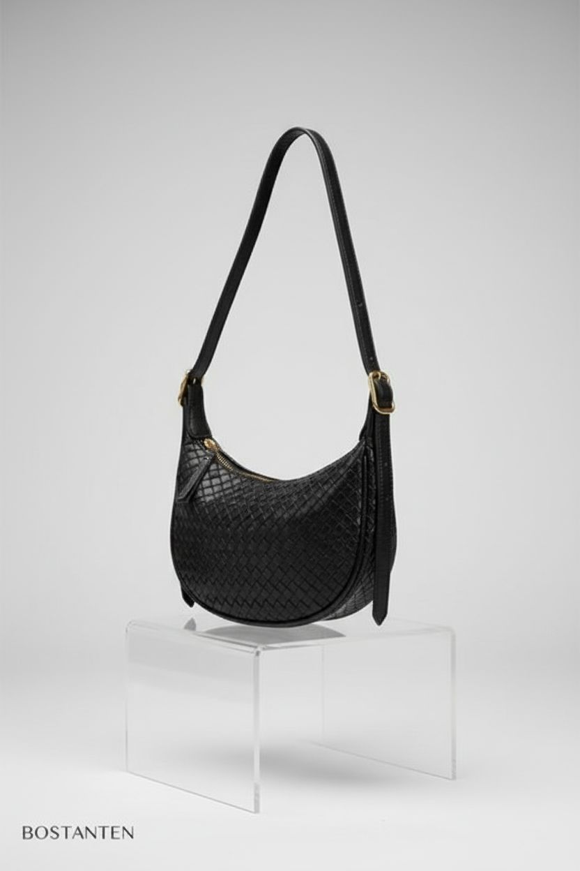 BOSTANTEN small black handbag displayed on a matte pedestal highlighting details