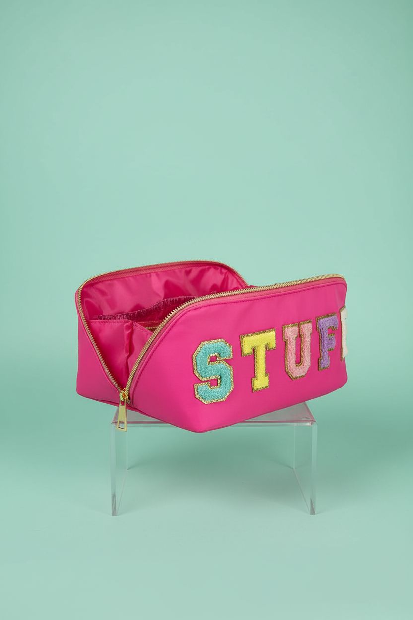 STOMKIRE rose red cosmetic bag displayed on a mint backdrop, highlighting compartments