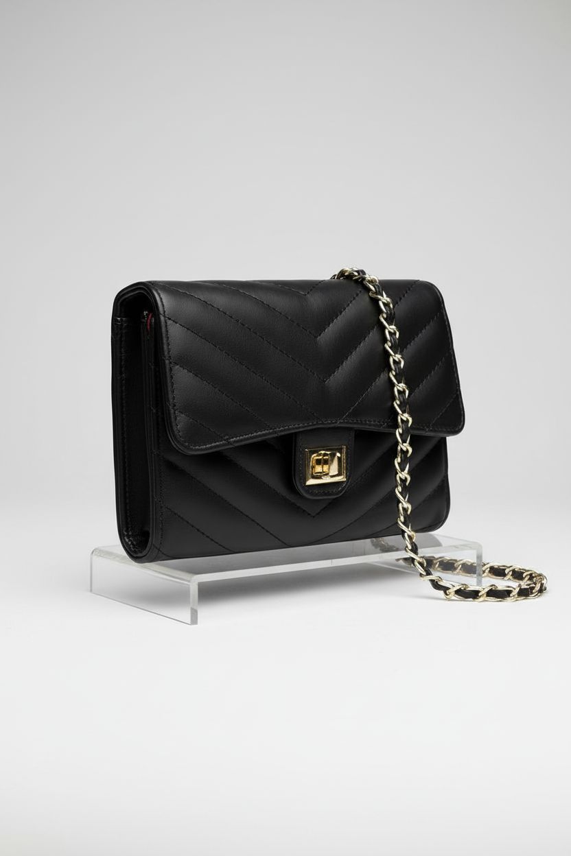 YAZEKOUS small black purse on a light gray backdrop, highlighting its leather texture.