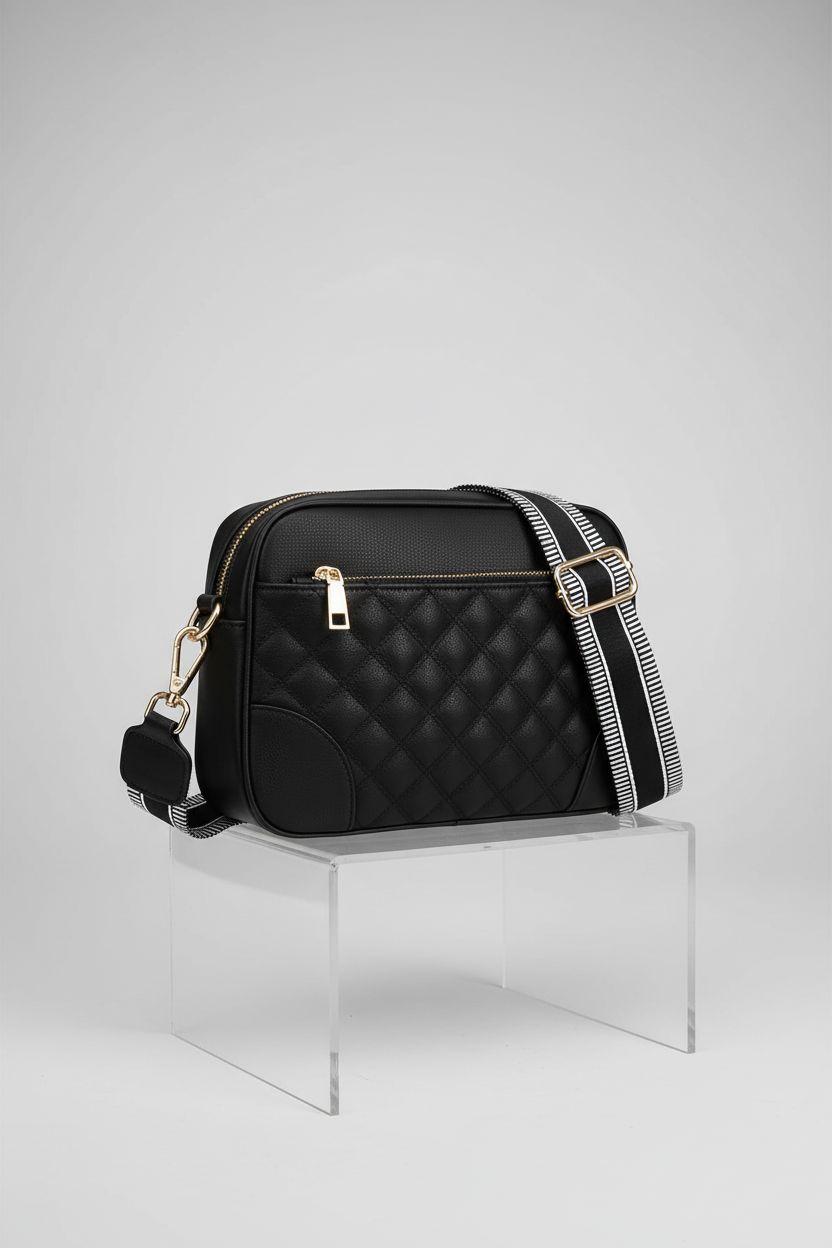 FYY black vegan crossbody bag displayed elegantly on a pedestal, highlighting its quality craftsmanship.