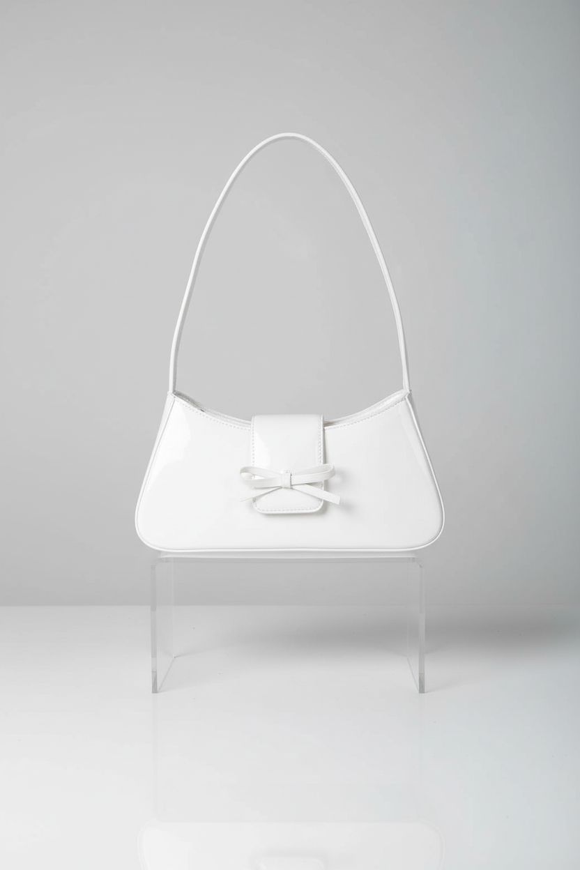 Sleek white trapezoid handbag on an acrylic display, emphasizing its glossy finish, designed by Amszke.