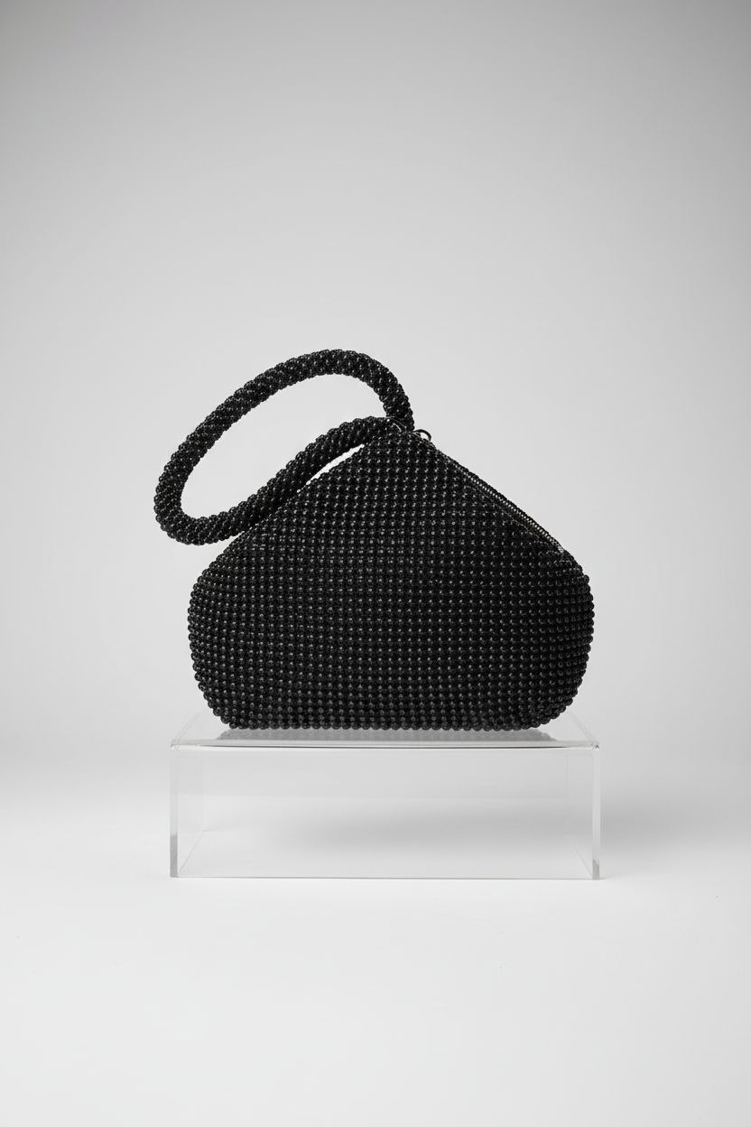 Minimalist display of BABEYOND little black beaded bag showcasing its exquisite triangular design.