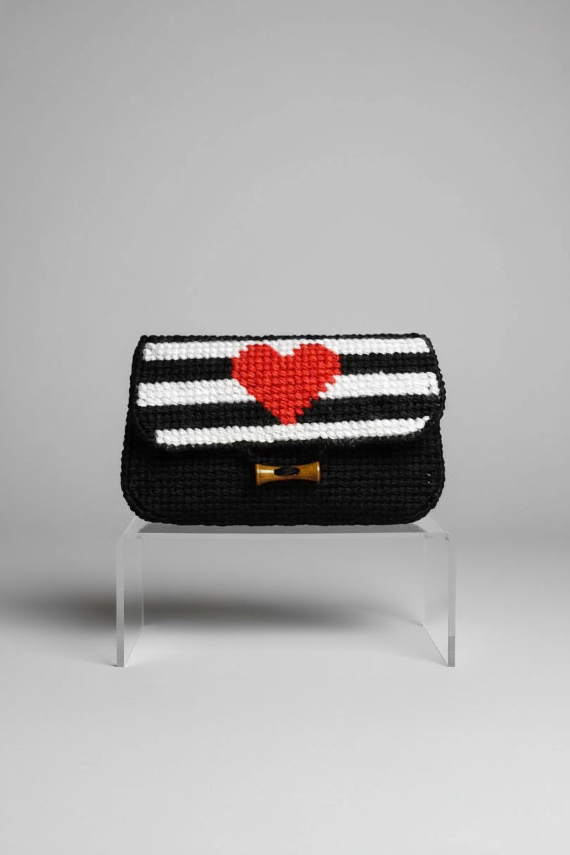 Orchidea needlepoint clutch bag on a clean studio backdrop, showcasing detailed craftsmanship and design.