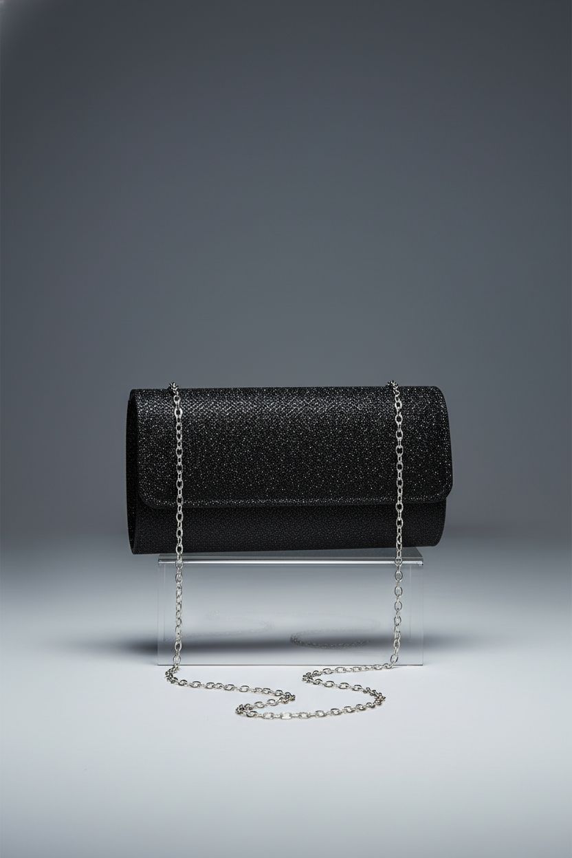 Product shot of lovyoCoCo black glitter clutch with elegant chain on a clean studio backdrop.