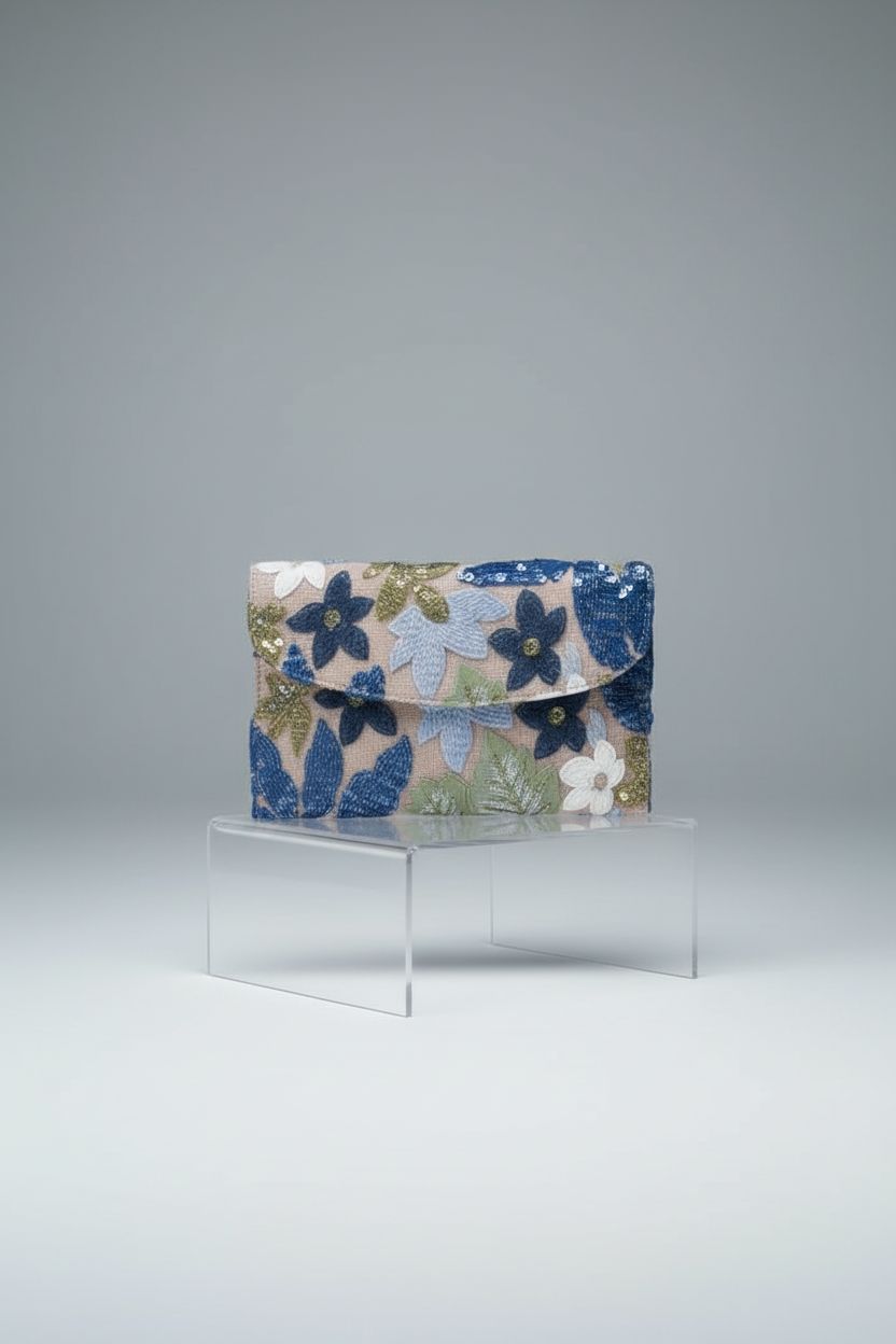 Verdusa blue sequin embroidered clutch showcased on acrylic riser in studio