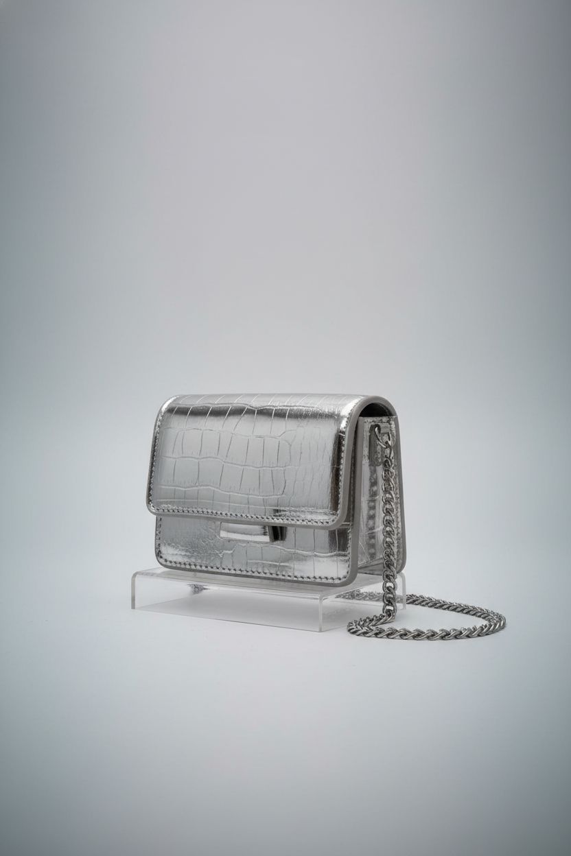 Anytiger silver mini handbag showcased on acrylic riser, highlighting its sleek design.