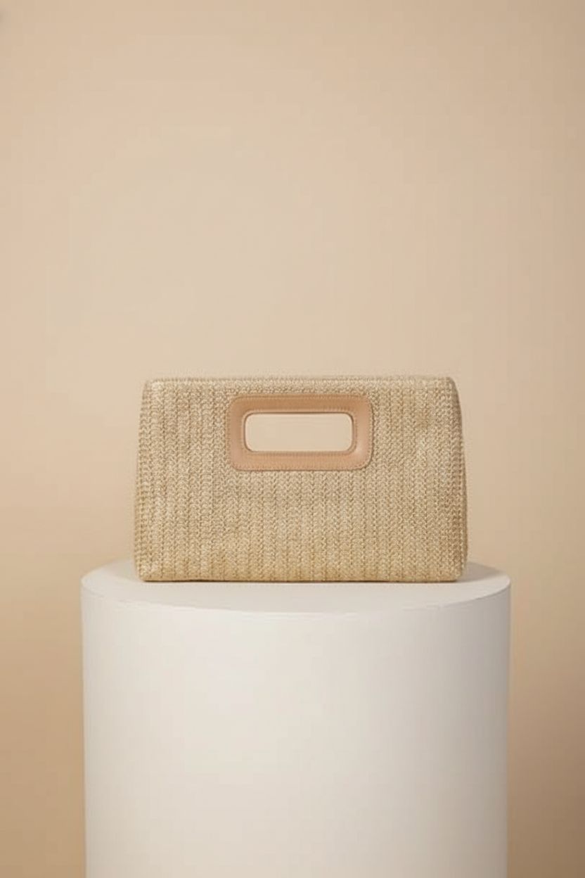 Kseymeir woven straw handbag showcasing detailed craftsmanship on a neutral backdrop.