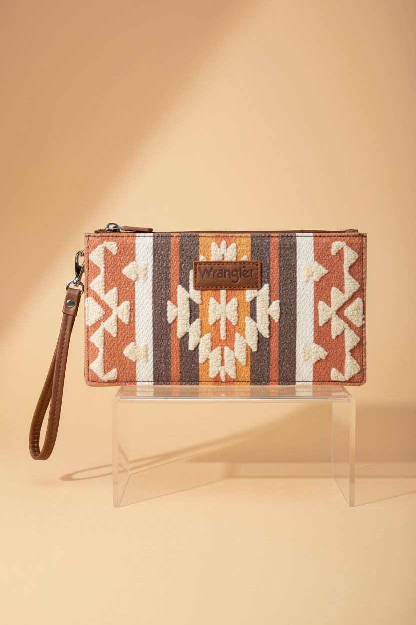 Montana West Aztec wristlet on acrylic riser, highlighting intricate stitching and design.
