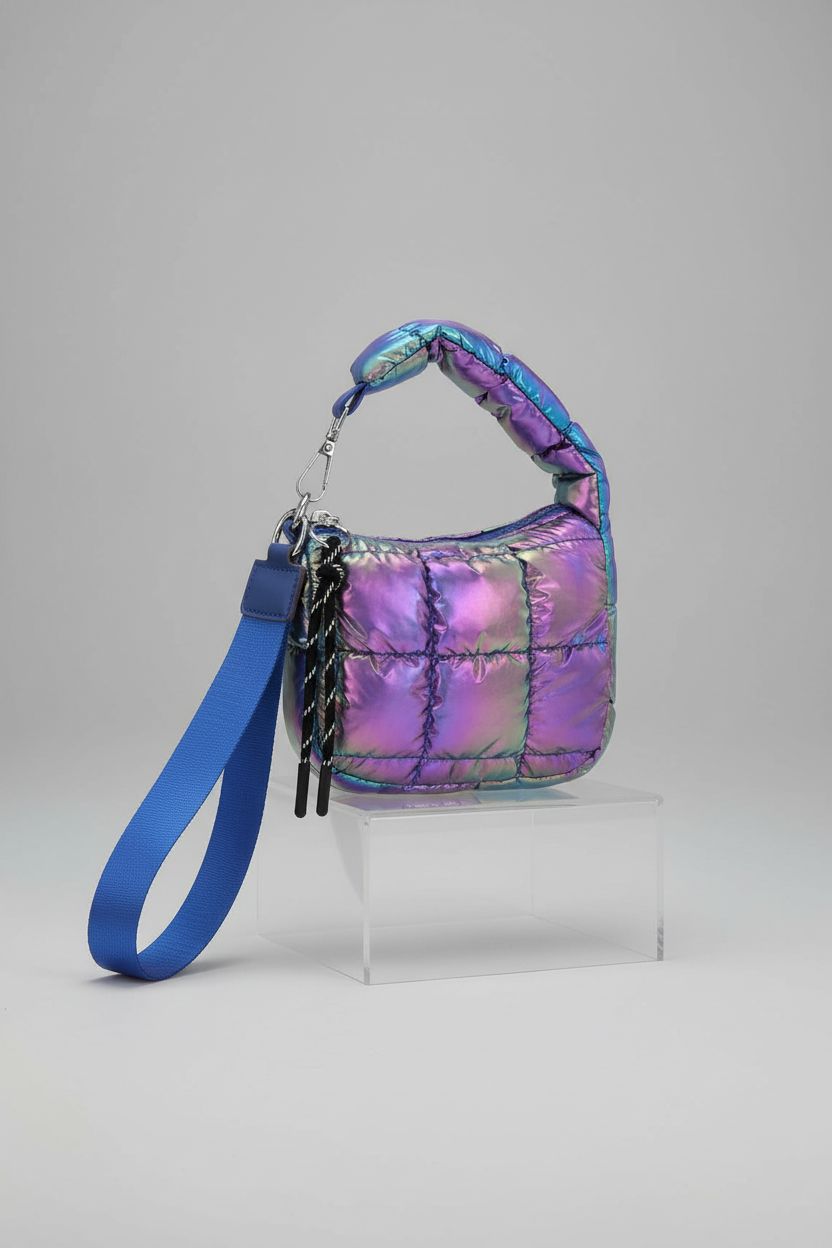 SUKUTU Mini Quilted Wristlet Bag displayed on an acrylic block, highlighting its elegant puffer design.